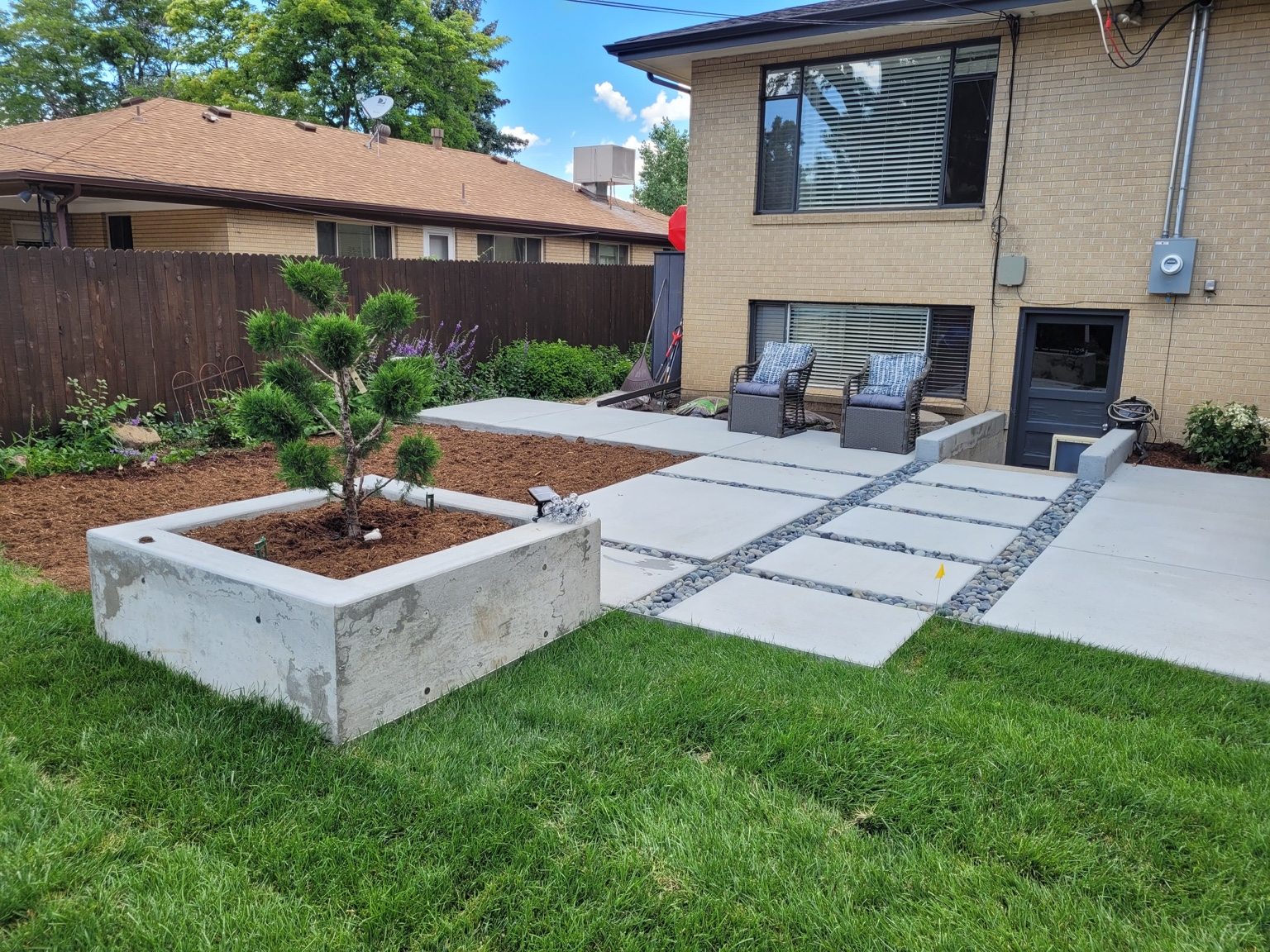 Finished backyard concrete patio and walkways